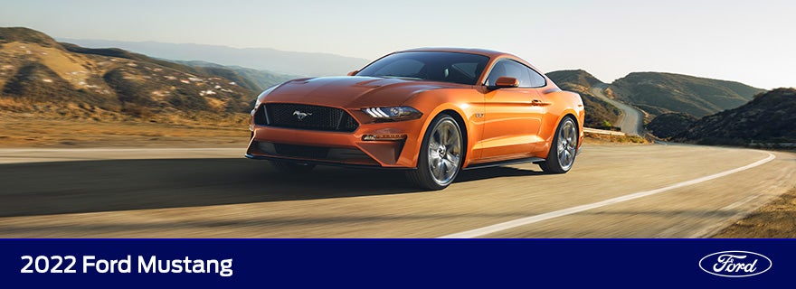 orange mustang on open road